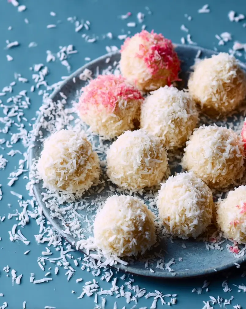 Coconut Cake Snowballs 3 Cookie dough balls being placed onto a baking sheet